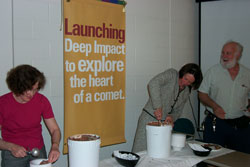 Deep Impact PI Mike A'Hearn coaches University of Maryland's Provost, Ann Wylie, and science team member, Lucy McFadden, in scooping Comet Crunch ice cream for its debut at the University.